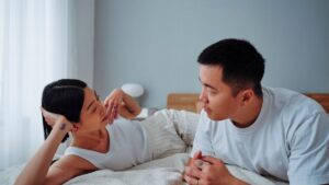 Couple talking in bed