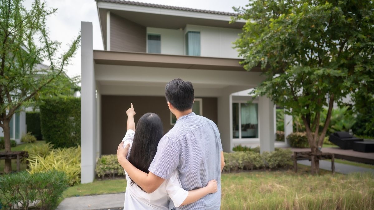 Couple outside their house