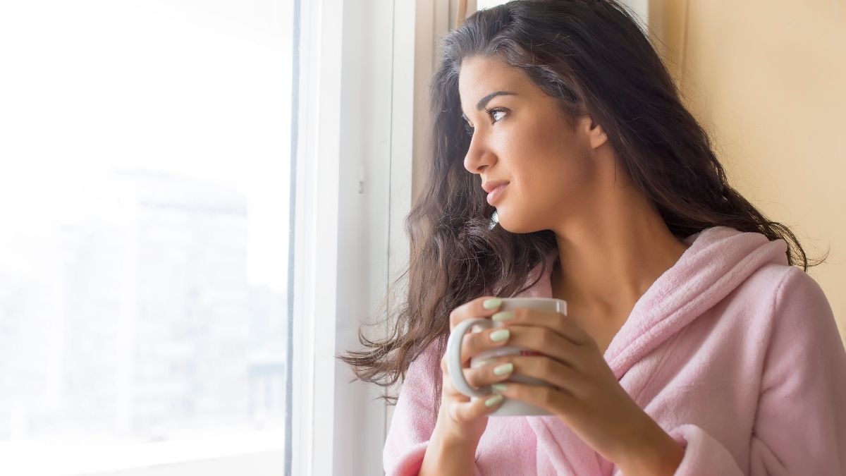 Woman with coffee cup at home