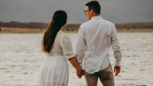 Couple holding hands at the beach