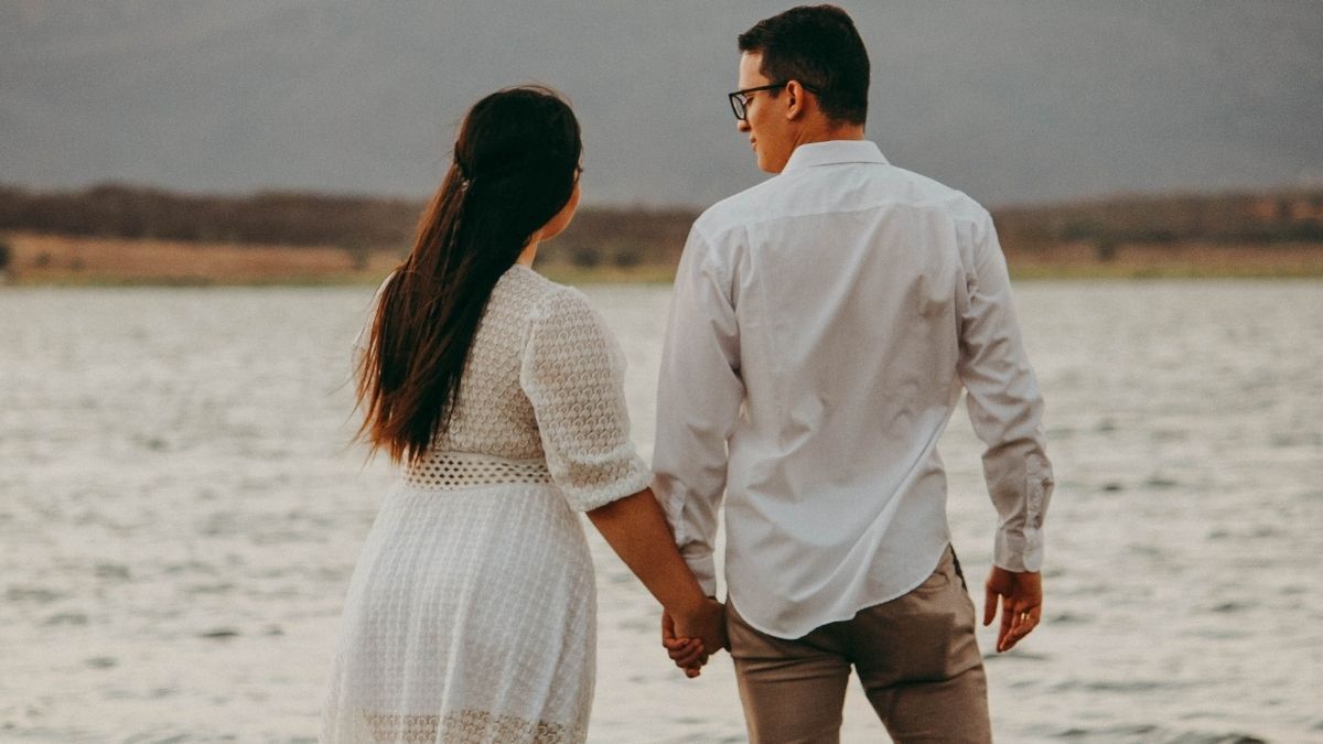 Couple holding hands at the beach