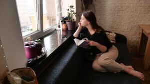 Woman sitting at home with a book